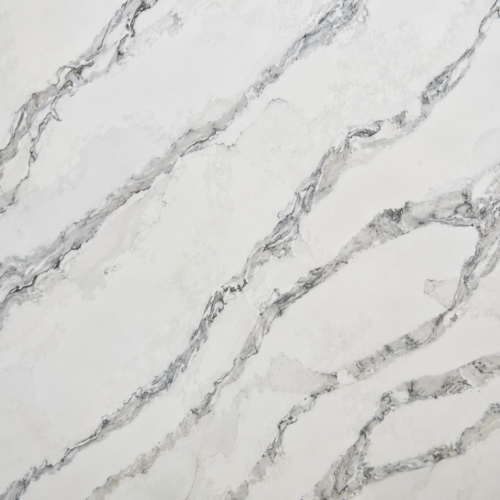 Close-up of Saint Elias quartz slab showing soft grey diagonal veining across a bright white background.