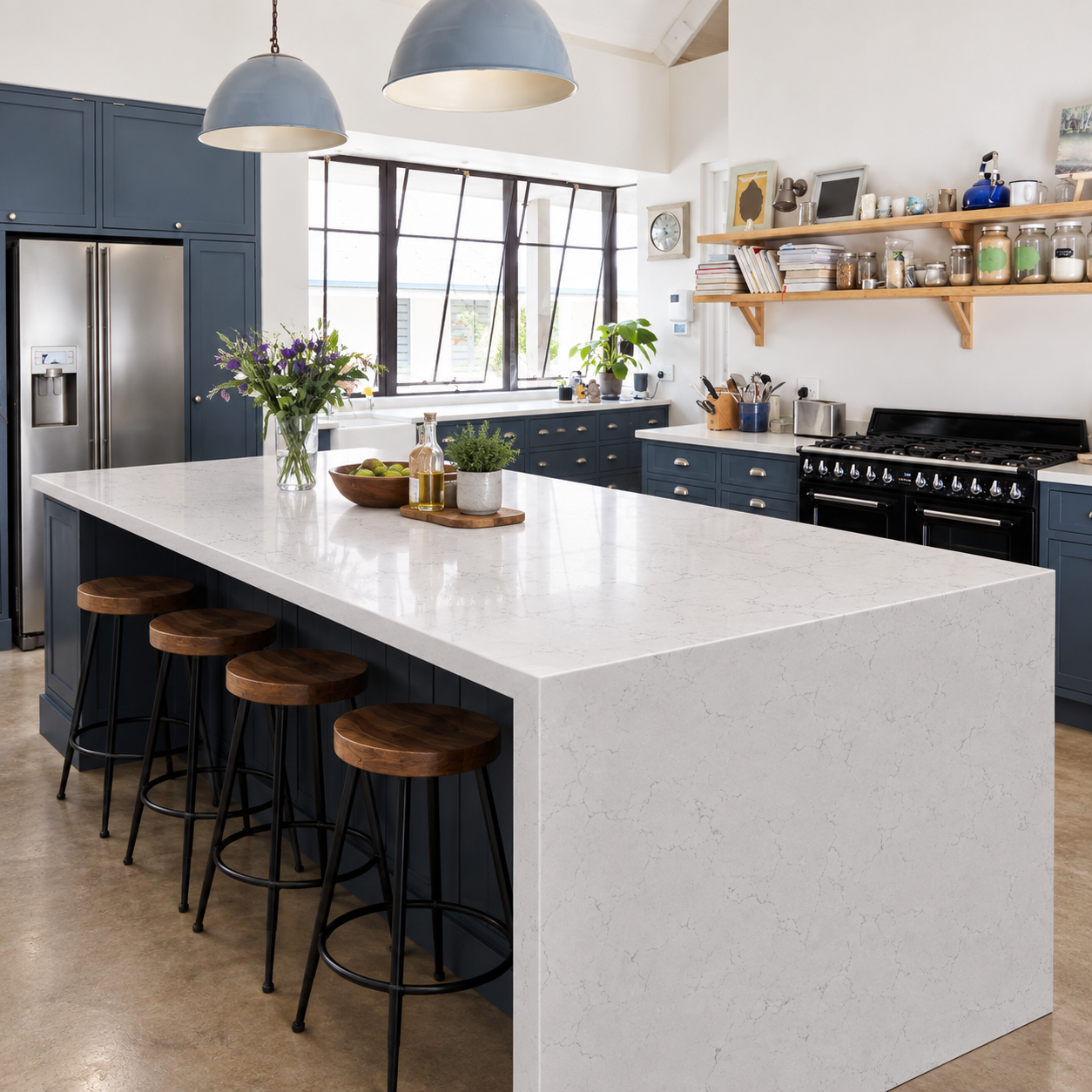 Carrara Edison quartz waterfall island in a navy blue farmhouse kitchen