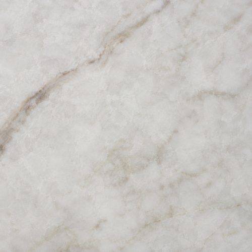 Close-up of Taj Mahal quartz slab with warm cream base and soft golden taupe veining.